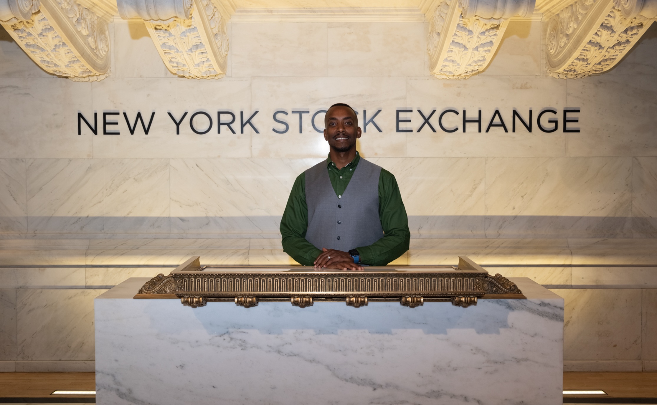 Man standing in front of NYSE sign
