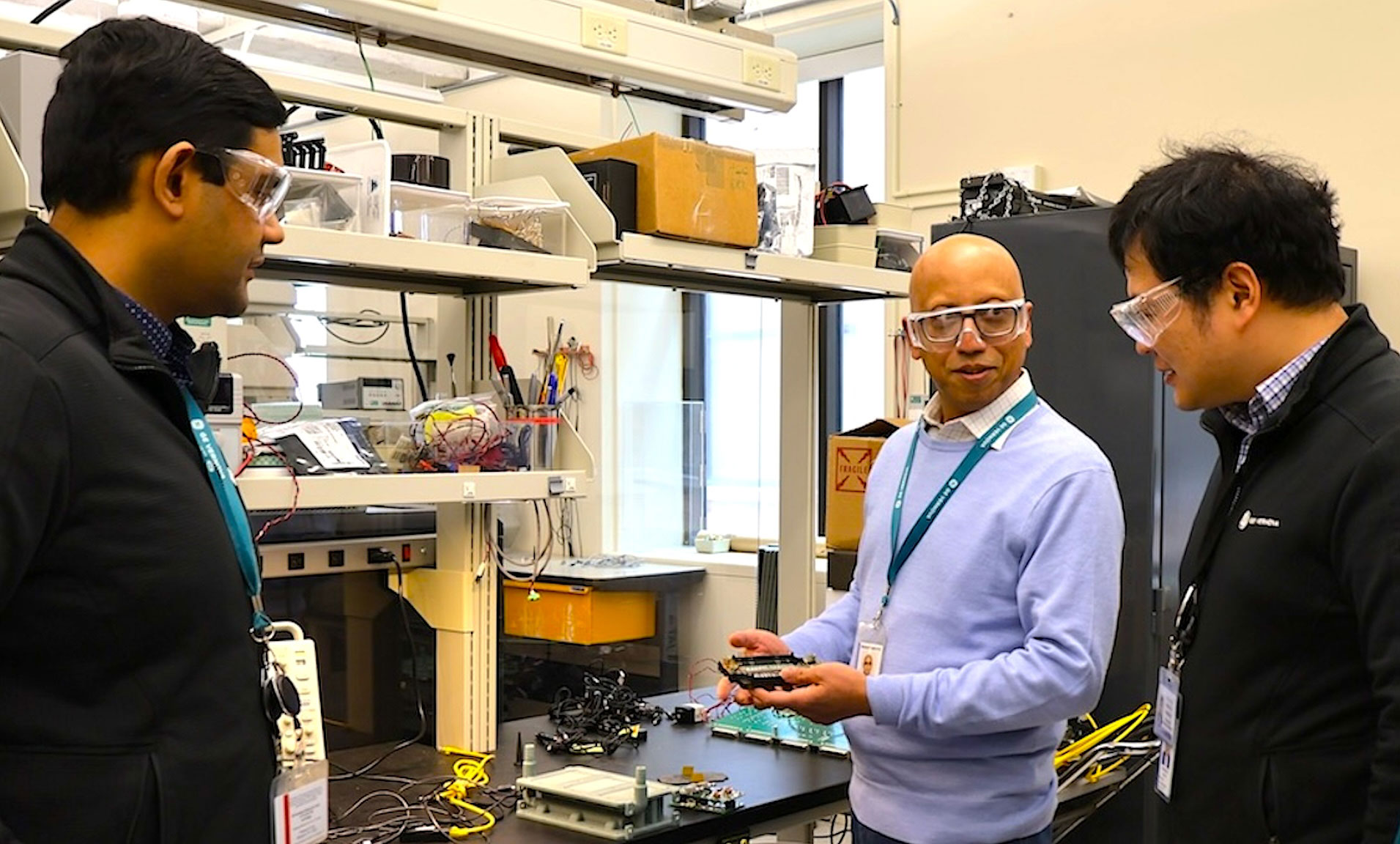 Men wearing safety googles discuss in a lab